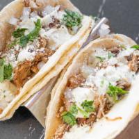 Street Tacos · Two warm corn tortillas, choice of meat, minced red onion, queso fresco, jalapeno lime dress...