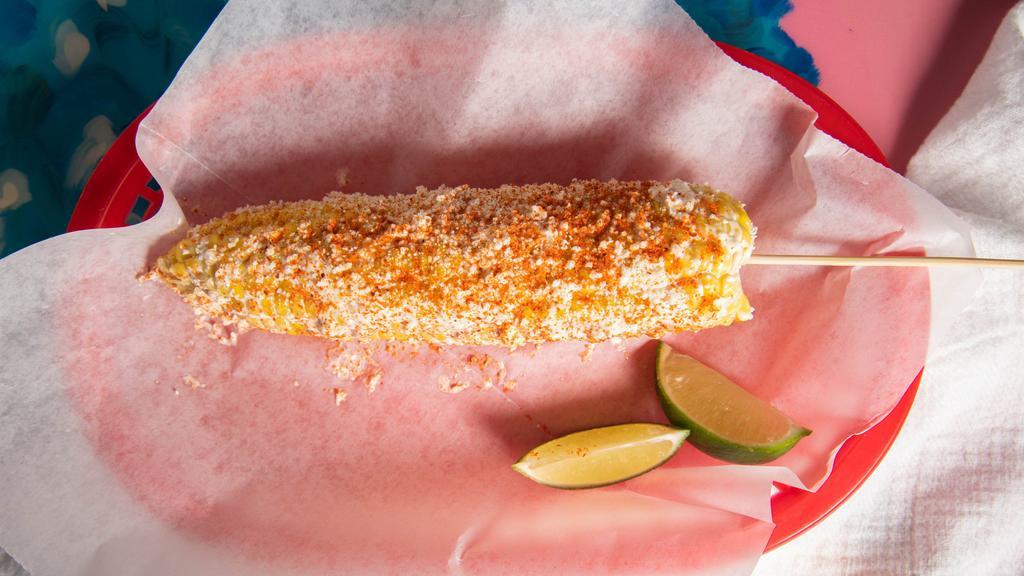 Mexican Street Corn · Corn On a Cob Coated With Crumbled Cotija Cheese, Light Mayo, Butter, and Spiced With Chili Powder