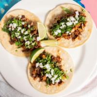 Tacos Campechanos · 3 Tacos, a Mixture of Chorizo, Carnitas, Carne Asada All In One Taco. Served With Rice and B...