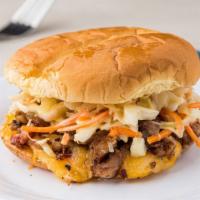Hawaiian Pork Sandwich · Smoked pork, lime slaw, BBQ sauce, and a 4 cheese blend on a Hawaiian bun.