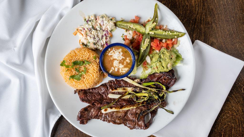 Carne Asada Chimichanga Dinner · Stuffed with skirt steak, roasted corn, caramelized onions, roasted pimiento peppers, mushrooms and queso fresco. Topped a roasted poblano cream sauce, guacamole and sour cream, rice and beans.
