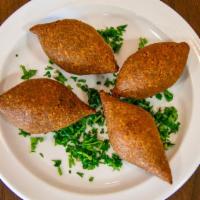 Kibbeh · A shell of bulgur wheat and minced beef stuffed with ground beef, garlic and spices deep fri...