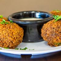 Falafel · Chickpeas, onions, parsley, garlic, spices, deep fried, served with tahini dip.