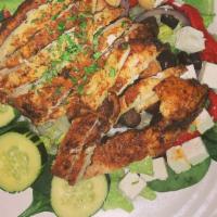 Spicy Garden Salad · Blackened chicken over spinach and romaine lettuce with Feta cheese, roasted red peppers, bl...
