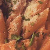 Penne Pasta In Pink Vodka Sauce · With grilled chicken strips and a side of garlic bread.