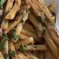 Feta Fries · Crispy golden brown fries topped with feta cheese, garlic sauce, oregano and parsley.