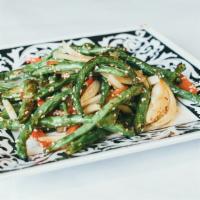 Fried Green Beans · Dry-fried green beans with chili peppers and onions, and sprinkled with sesame oil and salt.