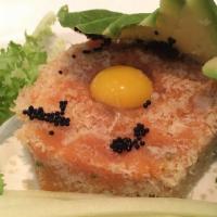 Spicy Tuna Tartar · Spicy tuna topped with tobiko, crunchy and quail egg with sliced avocado and cucumber on the...