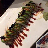 Dragon Roll · Broiled eel and cucumber inside. Topped with avocado, masago, and eel sauce.