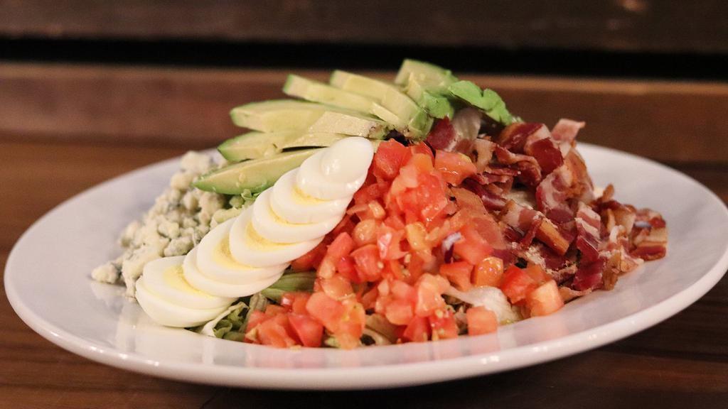 Cobb Salad · Chicken breast, bacon, crumbled bleu cheese, diced tomatoes, avocado and a hardboiled egg served on a bed of crisp lettuce with your choice of dressing.