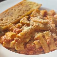 Rigatoni Bolognese · Spicy Italian sausage, garlic, oregano in a rich tomato and red pepper cream sauce, tossed w...