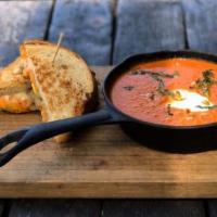 Soup & Sammie · Tomato basil soup, sour cream, pine nuts and grilled cheese sandwich.