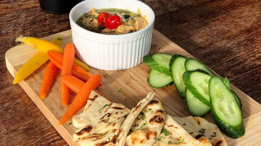 Hummus Plate · House made chimichurri hummus, warm pita bread, carrots, Persian cucumbers