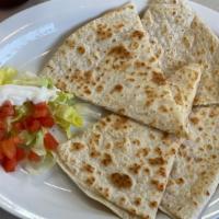 Quesadillas · Grilled flour tortilla with a monterey jack cheese, garnished with lettuce and sour cream.