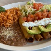 Fried Taquitos · Chicken/shredded beef wrapped in a fried corn tortilla and garnished with lettuce, tomatoes,...