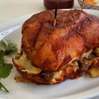 Pambazo Tortas · Bread dipped in red chille sauce with meat, beans, cheese and sour cream with meat (steak, m...