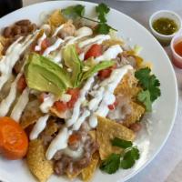 Nachos · Chips layered with re-fried beans, choice of meat and oven melted cheese, topped off with so...
