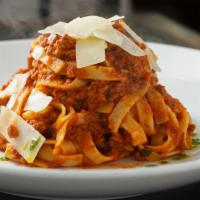 Fettuccine Alla Bolognese · fresh fettuccine pasta with veal ragu and shaved
Parmesan cheese