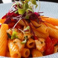 Rigatoni Alla Caprese · rigatoni pasta sautéed with cherry tomatoes, garlic, basil oil finished with fresh mozzarella