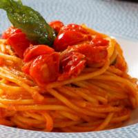 Spaghetti Al Pomodoro · spaghetti pasta sautéed with cherry tomatoes,
roasted garlic basil, and marinara sauce