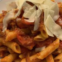 Penne All’ Amatriciana · penne pasta sautéed with applewood bacon, onions, tomatoes and a touch of chili flakes peppers