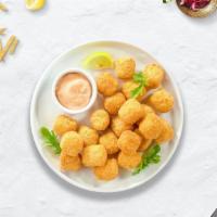 Tater Tots · Shredded Idaho potatoes formed into tots, battered, and fried until golden brown.