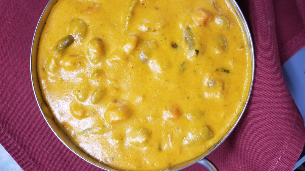Navaratna Korma · Mixed seasonal vegetables cooked with coconut milk, creamy sauce, cashew nut, raisin, almond and himalayan herbs and spices.