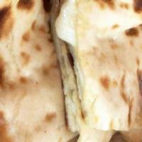 Naan · Traditionally baked bread in the clay oven.