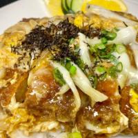 Pork Donburi · Deep fried breaded pork cutlet, egg and vegetables served over steamed rice.