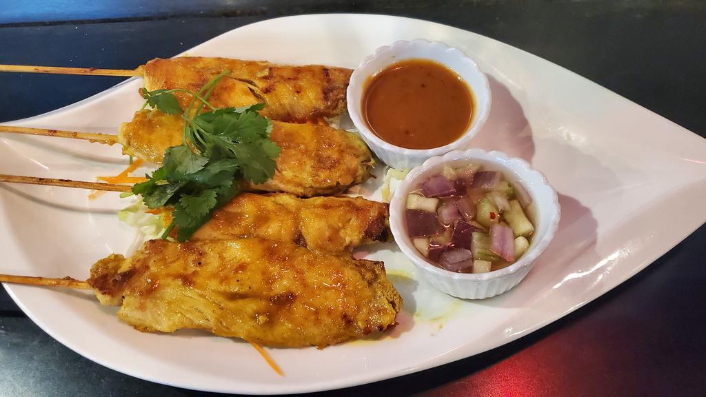 Chicken Satay (4) · Marinated chicken breasts on skewers, grilled and served with creamy peanut sauce and cucumber salad sauce.