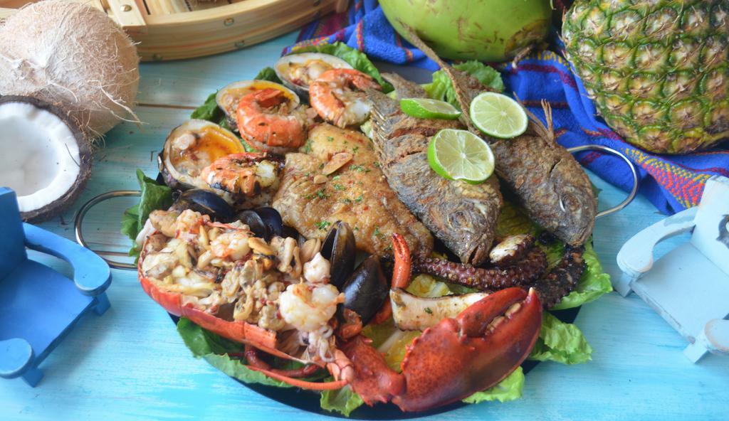 Bandeja El Puerto · fry hole Fish, Filet Tilapia , 1/2 Lobster, Pulpo,  Shrimps ,Mussels, Clams, Seafood Mix., Serve with rice, green salad, and fresh made Tortilla.