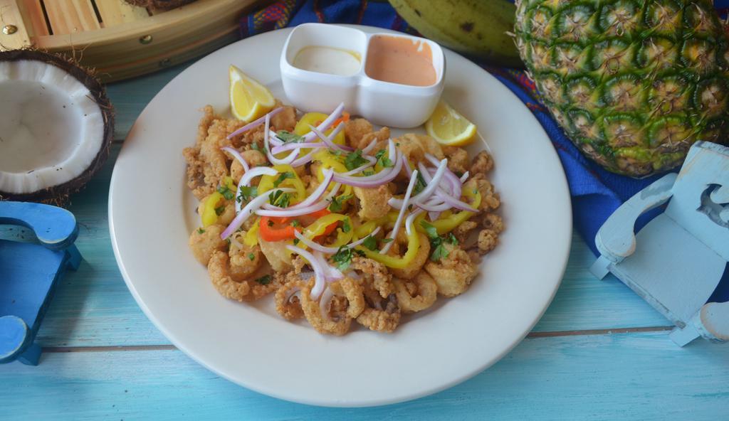Calamar Frito · Fried calamari serve with peppers red onion and chipotle sauce
