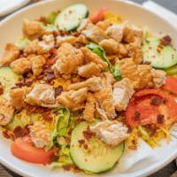 Crispy Chicken Salad · Diced chicken tenders, tomatoes, cucumbers, bacon, Cheddar cheese.