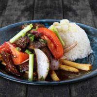 Lomo Saltado · Tender steak sautéed in oil with onions and tomatoes. Served over french fries and rice.
