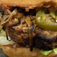 Couch Potato Burger · Pan seared slab of green chili meatloaf, grilled onions, mama Tuddy's candied jalapeños, blo...