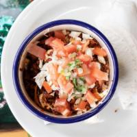 Chorizo Con Queso · Spicy Mexican chorizo mixed with diced tomatoes and red onions topped with melted queso Oaxa...