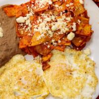 Chilaquiles Rojos · Fried Corn Tortillas smothered with our Specialty Sauce, topped with Queso Fresco a Side of ...