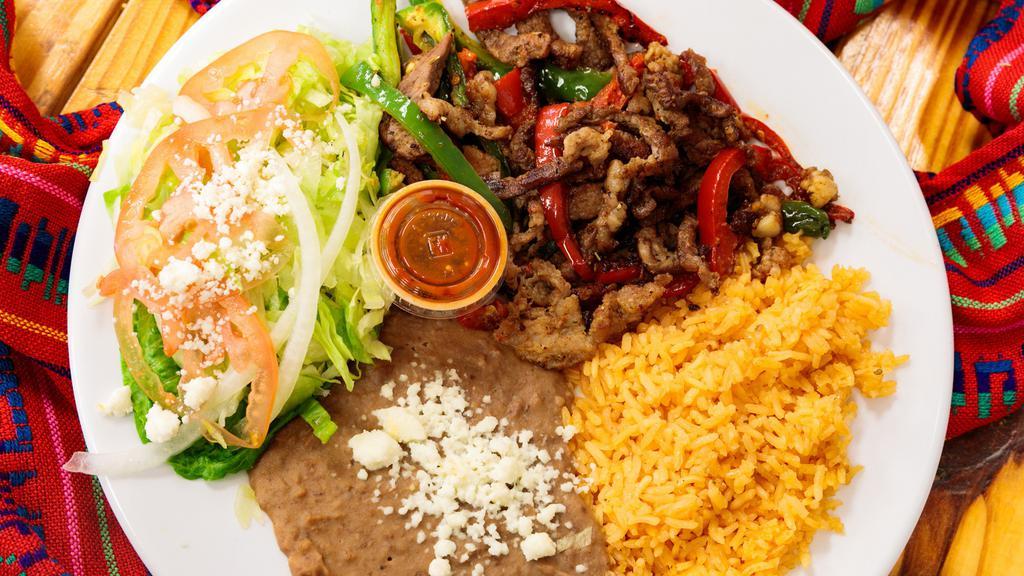 Fajitas De Res · 1 pound Fresh Fajitas smothered in onion, bell pepper and tomatoes with a side of rice and beans, fresh side salad. Includes fresh corn tortillas.
