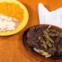 Carne Asada · Tender skirt steak topped with grilled onions, tomatoes and jalapeños. Served with rice, bea...