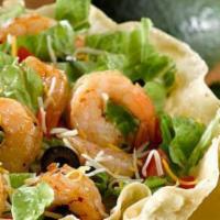 Shrimp Taco Salad · With bell peppers, lettuce, tomatoes, onions, cheese, sour cream, guacamole, and pico de gal...