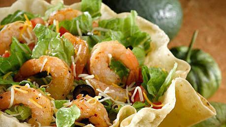 Shrimp Taco Salad · With bell peppers, lettuce, tomatoes, onions, cheese, sour cream, guacamole, and pico de gallo.