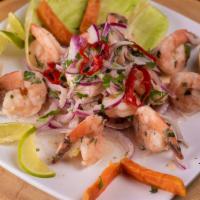 Ceviche De Camaron · Fresh shrimps marinated in lime juice; infused with red onions. Accompanied by Inca corn, po...