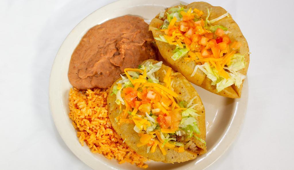 Puffy Taco Plate · Two puffy tacos (choice of beef, chicken, bean, or guacamole), rice, beans, and two corn tortillas.