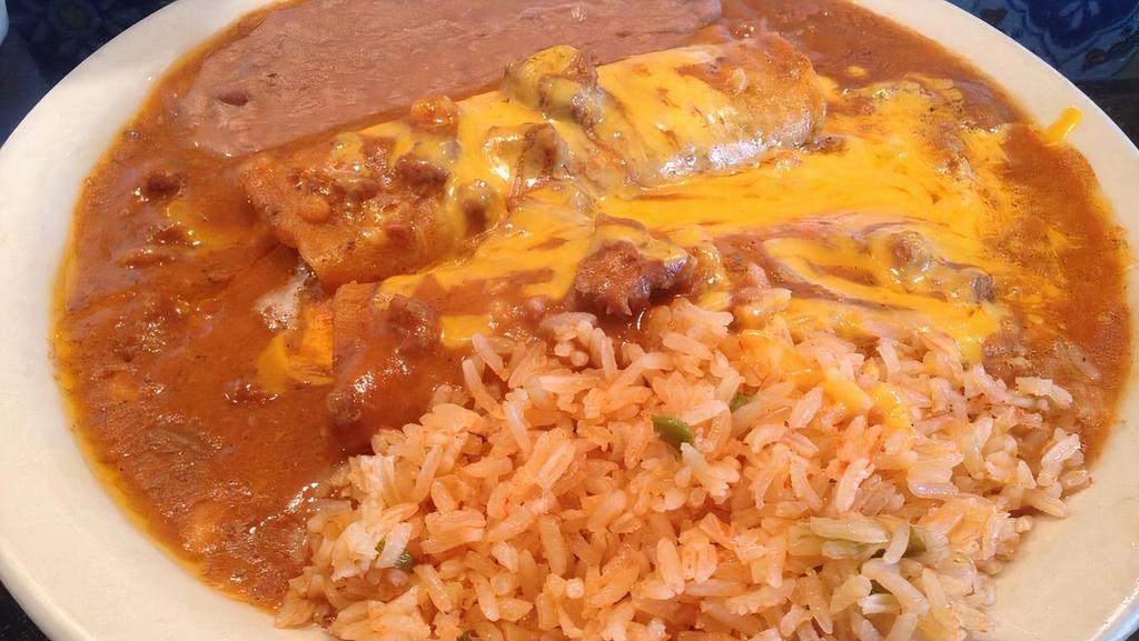 Beef Enchiladas · Two beef enchiladas topped with chili con carne and cheese, served with side of rice, beans and two corn tortillas. Onions available upon request