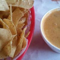 Chips & Queso · Half pint of queso, plus a bag of our homemade tortilla chips