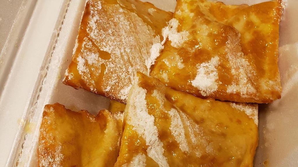 Sopapillas · Order of four traditional fried pastries topped with powdered sugar, cinnamon, and honey