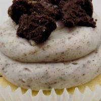Cookies & Cream · A vanilla cupcake topped with a cookies & cream buttercream and oreo cookie chunks.