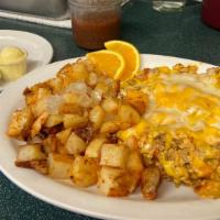 Chorizo Scramble · Chorizo with three scrambled eggs, tomatoes and onions topped with cheddar cheese, served wi...