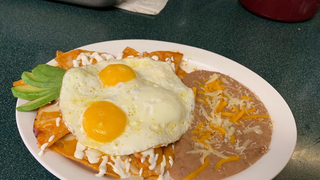 Chilaquiles Plate · Crispy tortilla strips smothered in our homemade ranchero sauce, cheese, sour cream, avocado and topped with 2 eggs. Served with beans or homefries