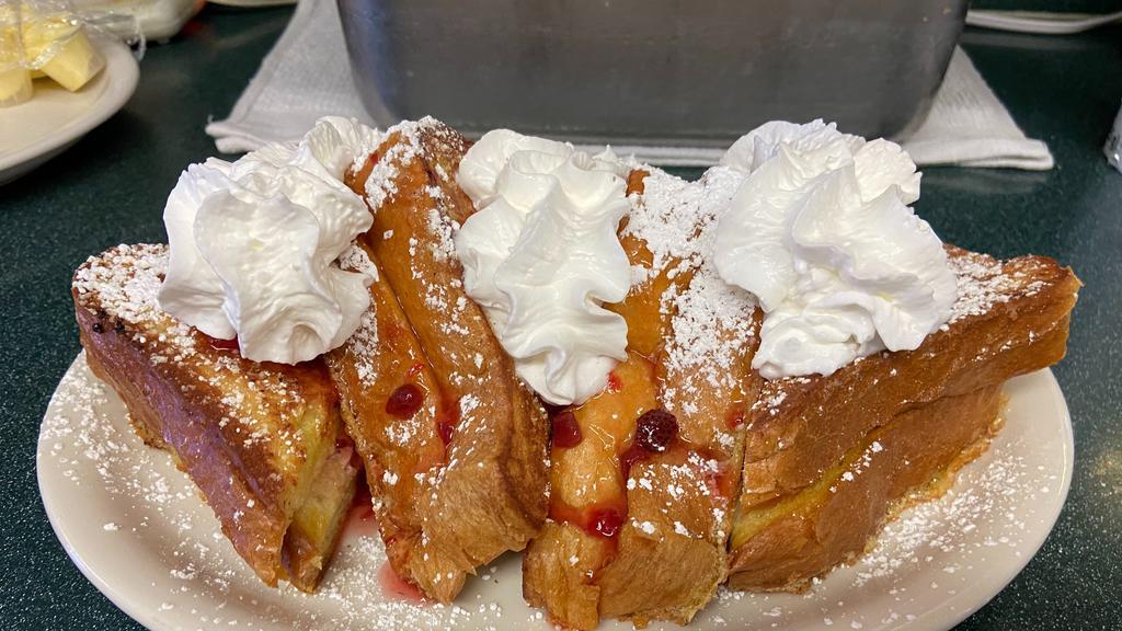 Stuffed French Toast · Three slices of our special french toast stuffed with cream cheese and strawberries topped with more strawberries and whipped cream.